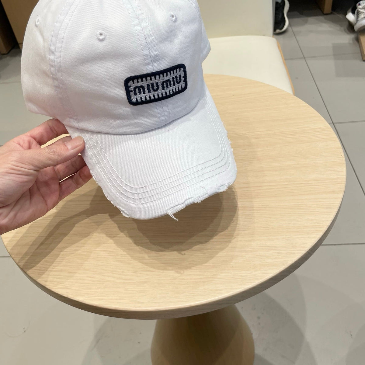 MIU MIU MM DISTRESSED FABRIC BASEBALL CAP IN WHITE WITH EMBROIDERED LOGO